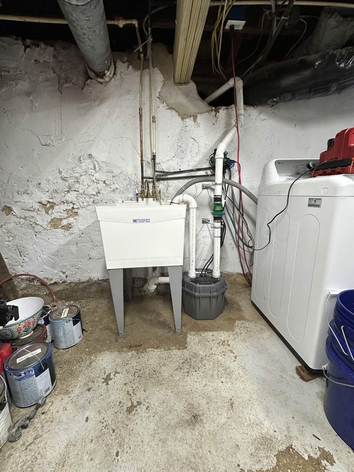 Utility sink and laundry ejector pump piped in a basement